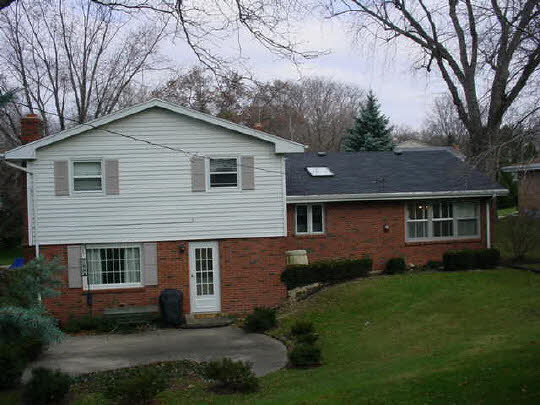 4851 Welsh Road Rockford, IL 61107 - Photo 6 of 6 a front view of a house with a garden and yard