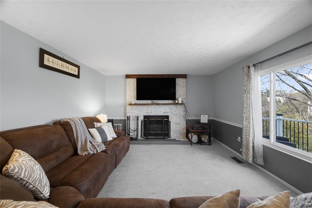 216 Briar Path Imperial, PA 15126 - Photo 11 of 39 a living room with furniture a fireplace and a flat screen tv