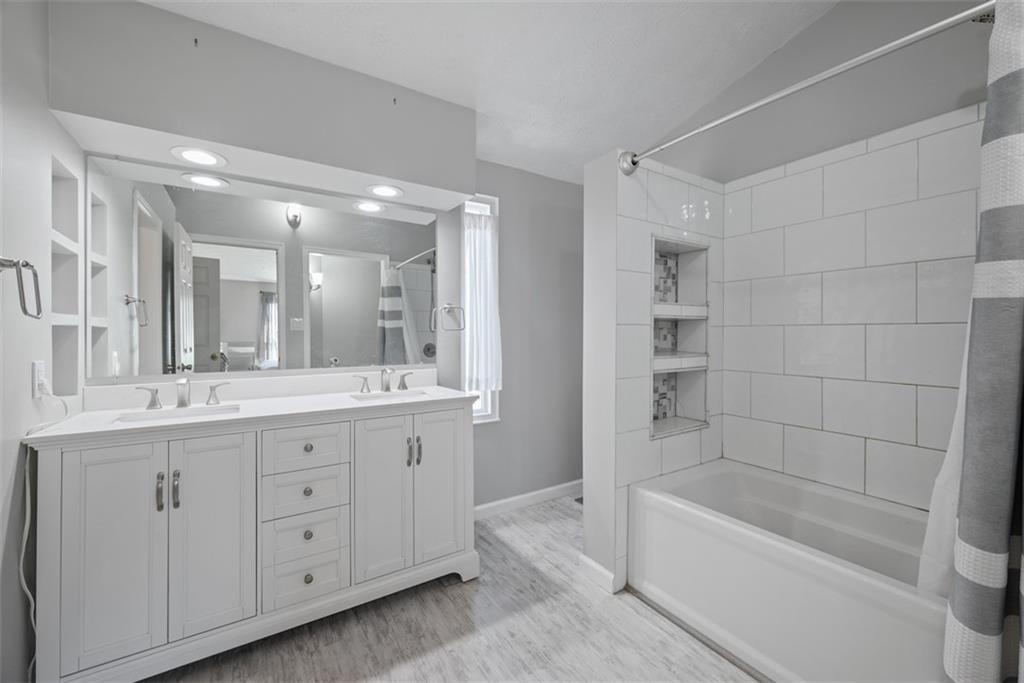 216 Briar Path Imperial, PA 15126 - Photo 21 of 39 a bathroom with a tub a double vanity sink and mirror