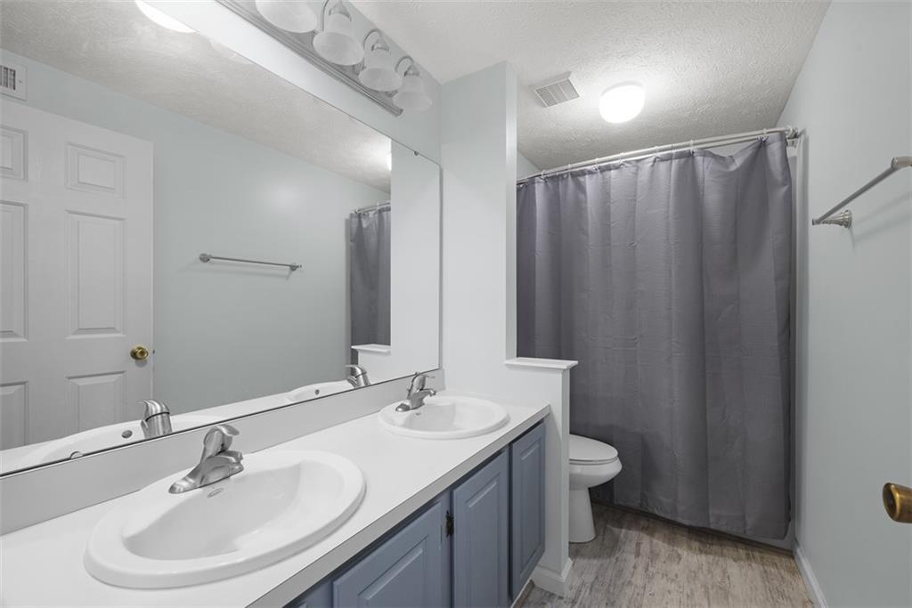 216 Briar Path Imperial, PA 15126 - Photo 30 of 39 a bathroom with a double vanity sink toilet and a mirror