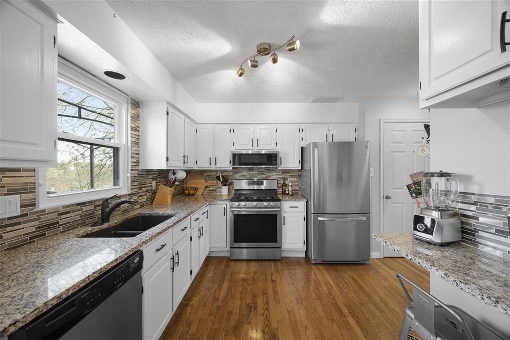 216 Briar Path Imperial, PA 15126 - Photo 8 of 39 a kitchen with refrigerator a sink and a stove