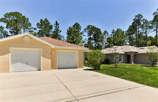 a view of a white house with a yard
