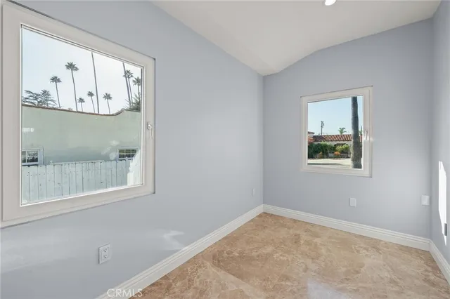 a view of a small space with wooden floor and a window