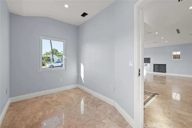 an empty room with windows and closet