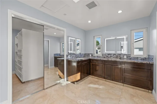a large bathroom with a sink and a large mirror