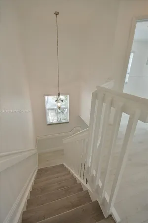 a view of a room with wooden floor and white walls