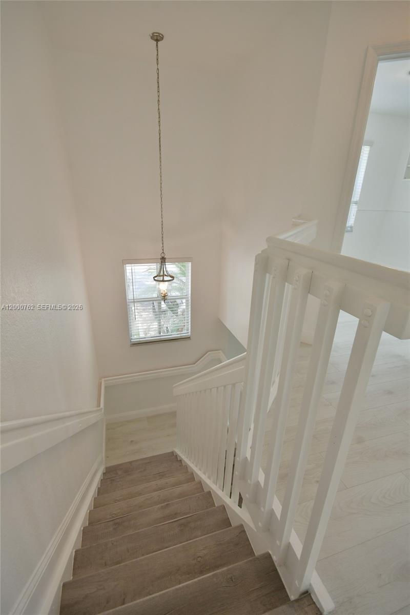 3177 Southwest 129th Way, Unit 134 Miramar, FL 33027 - Photo 16 of 34 a view of a room with wooden floor and white walls
