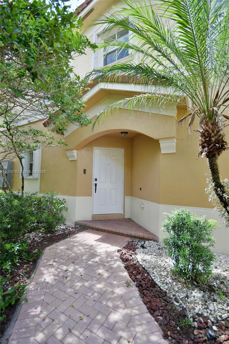 3177 Southwest 129th Way, Unit 134 Miramar, FL 33027 - Photo 2 of 34 a front view of a house with a yard and garage