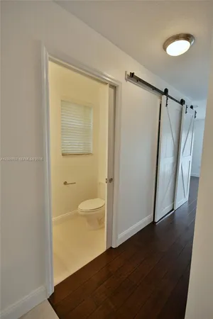 a view of walk in closet with wooden floor and window