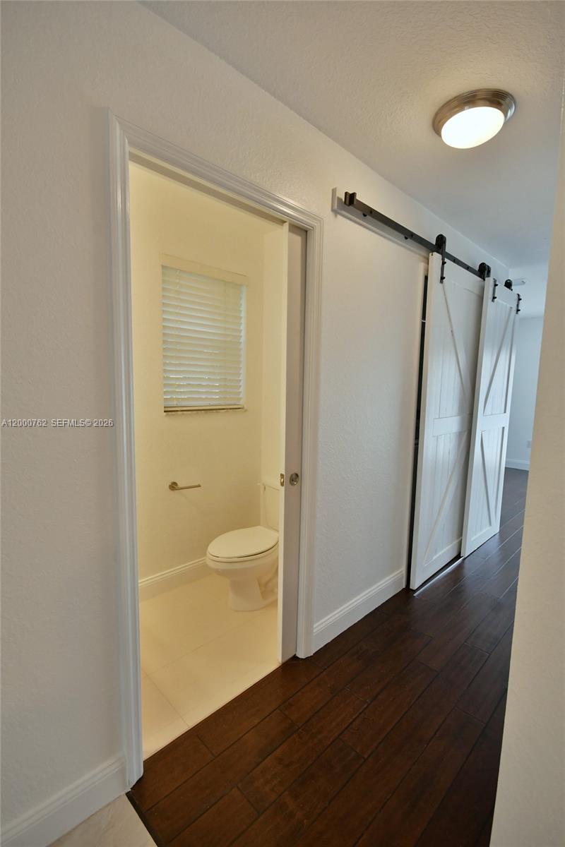 3177 Southwest 129th Way, Unit 134 Miramar, FL 33027 - Photo 5 of 34 a view of walk in closet with wooden floor and window