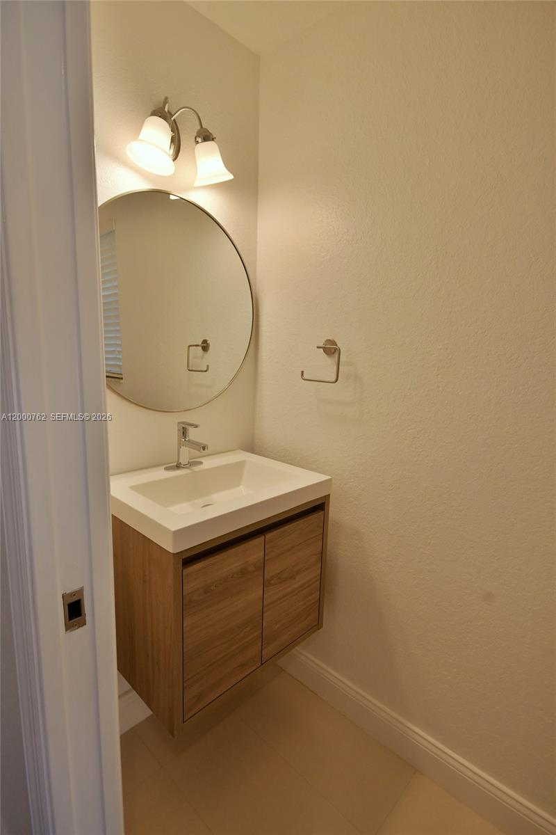 3177 Southwest 129th Way, Unit 134 Miramar, FL 33027 - Photo 6 of 34 a bathroom with a sink and a mirror