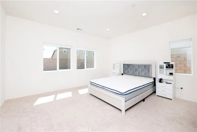 a bedroom with a bed and window