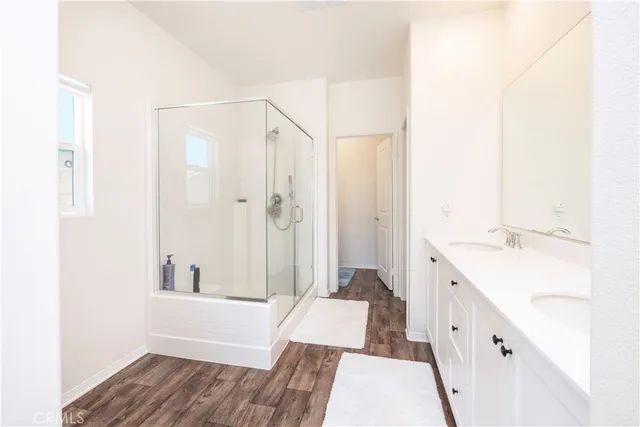 a bathroom with a tub sink and mirror