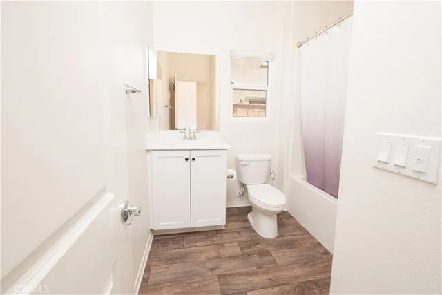 a white toilet sitting next to a bath tub