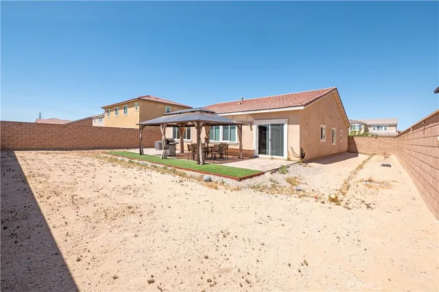 a view of a backyard with a garden and patio