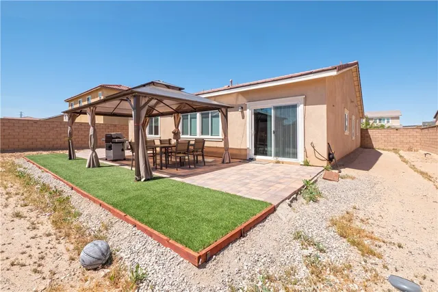 a view of a porch with furniture and backyard