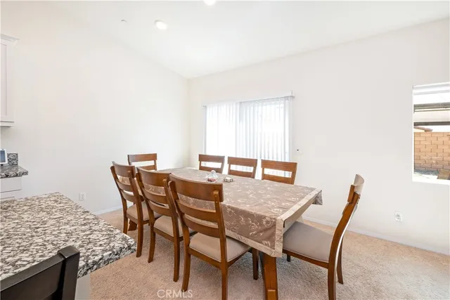 a view of a dining room that has a table and chairs in it
