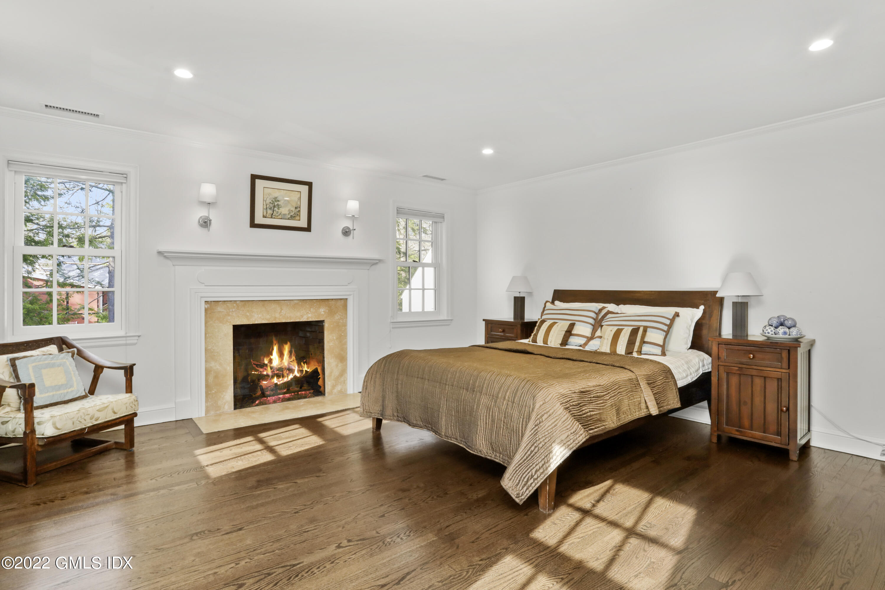 99 Husted Lane Greenwich, CT 06830 - Photo 16 of 27 a bedroom with a bed and a fireplace