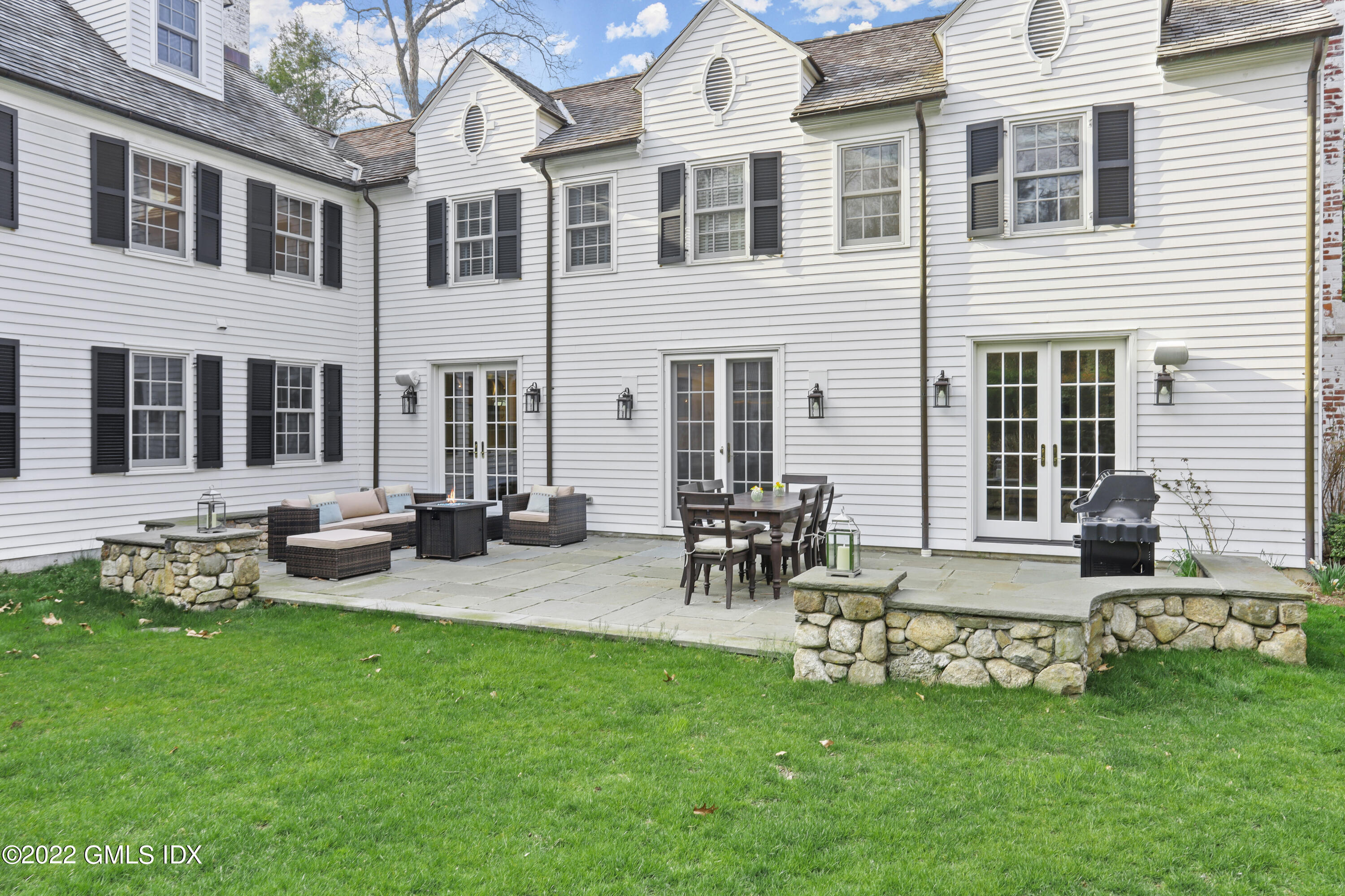 99 Husted Lane Greenwich, CT 06830 - Photo 21 of 27 a view of a chair and table in backyard of the house