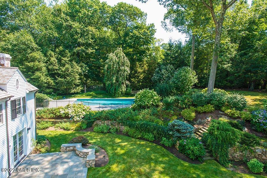 99 Husted Lane Greenwich, CT 06830 - Photo 24 of 27 a view of a garden with a building in the background
