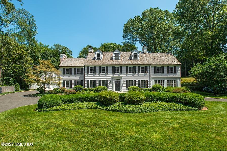 99 Husted Lane Greenwich, CT 06830 - Photo 3 of 27 a front view of a house with a yard and trees