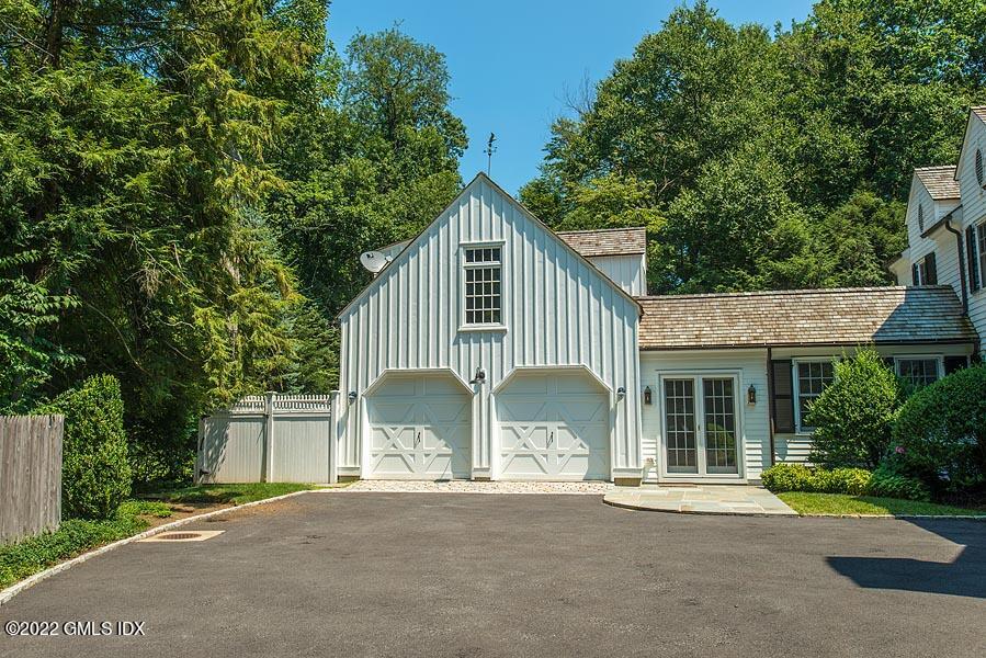 99 Husted Lane Greenwich, CT 06830 - Photo 4 of 27 front view of a house with a garden