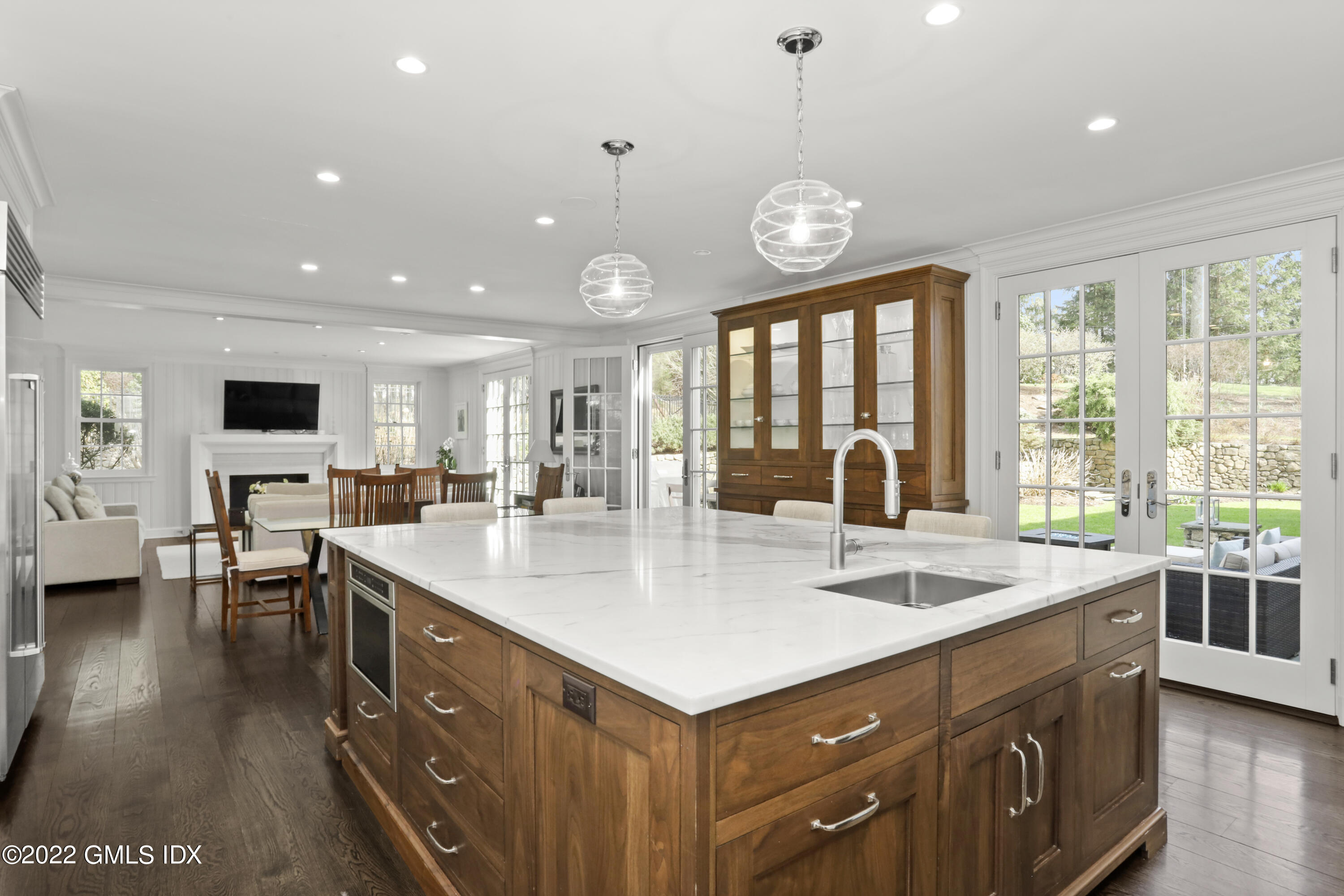 99 Husted Lane Greenwich, CT 06830 - Photo 9 of 27 a large kitchen with kitchen island a large island in it