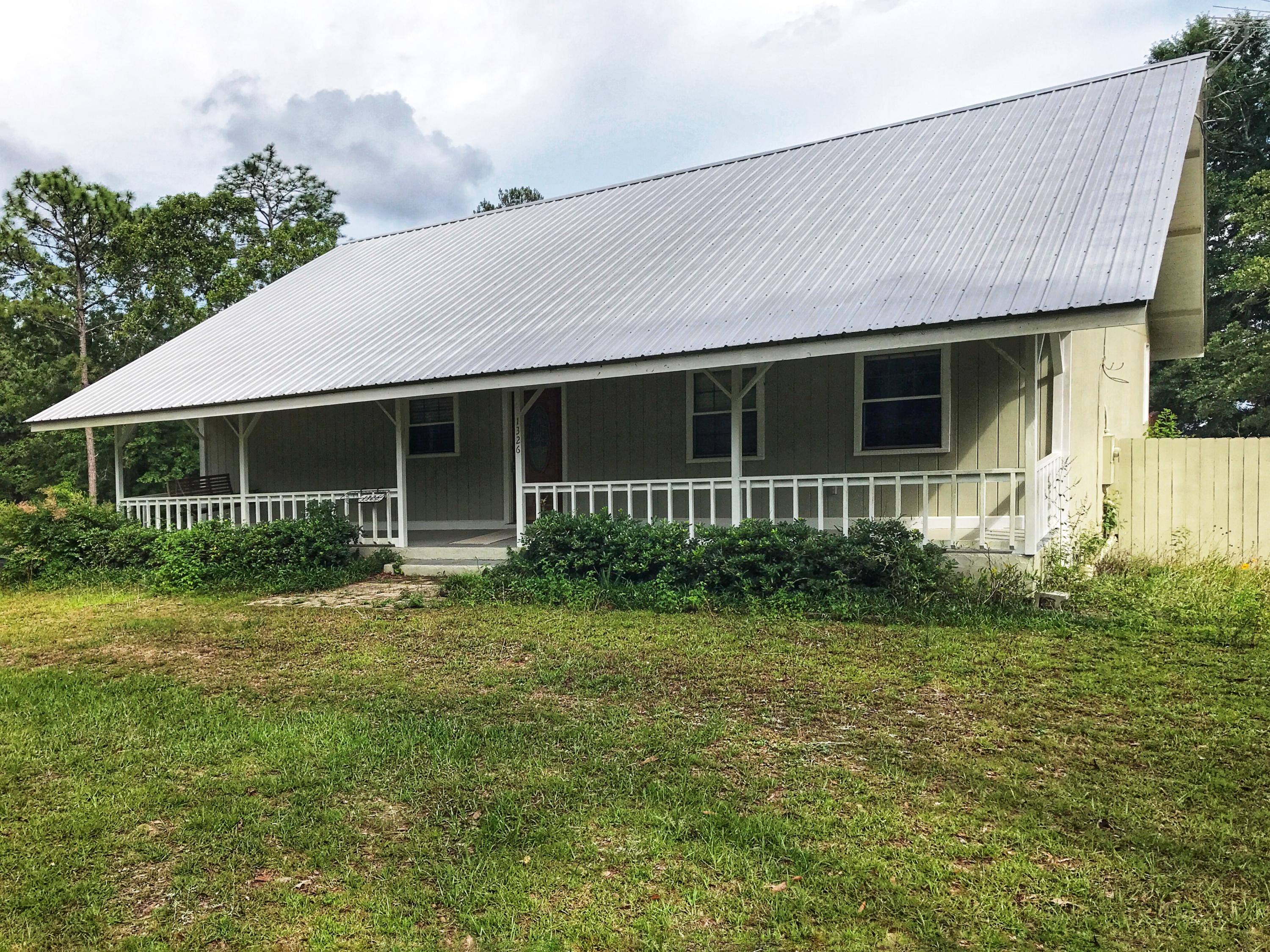1326 Spring Lake Road DeFuniak Springs, FL 32433 - Photo 1 of 25 a front view of house with yard and green space