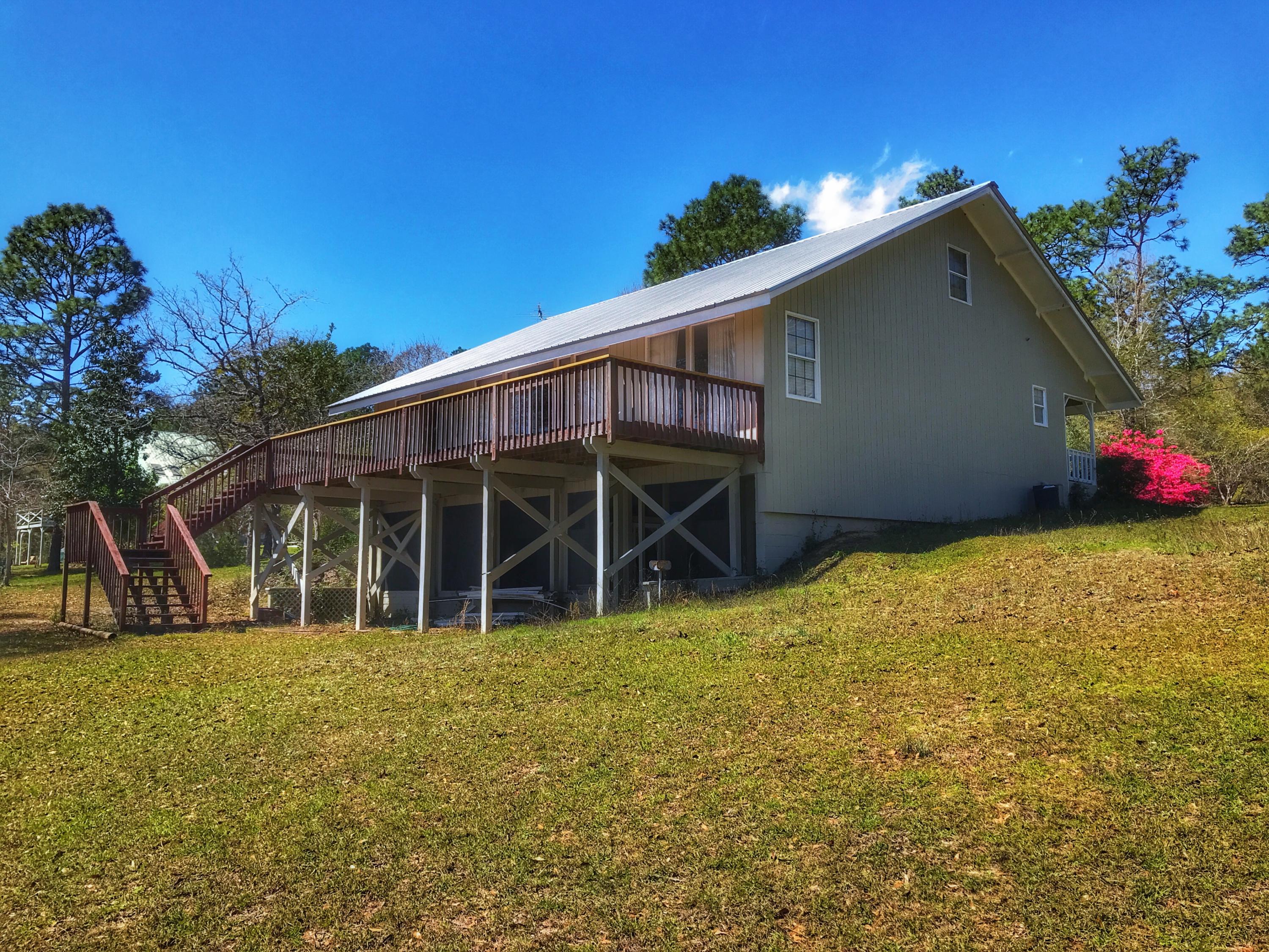 1326 Spring Lake Road DeFuniak Springs, FL 32433 - Photo 25 of 25 a view of a house with a big yard