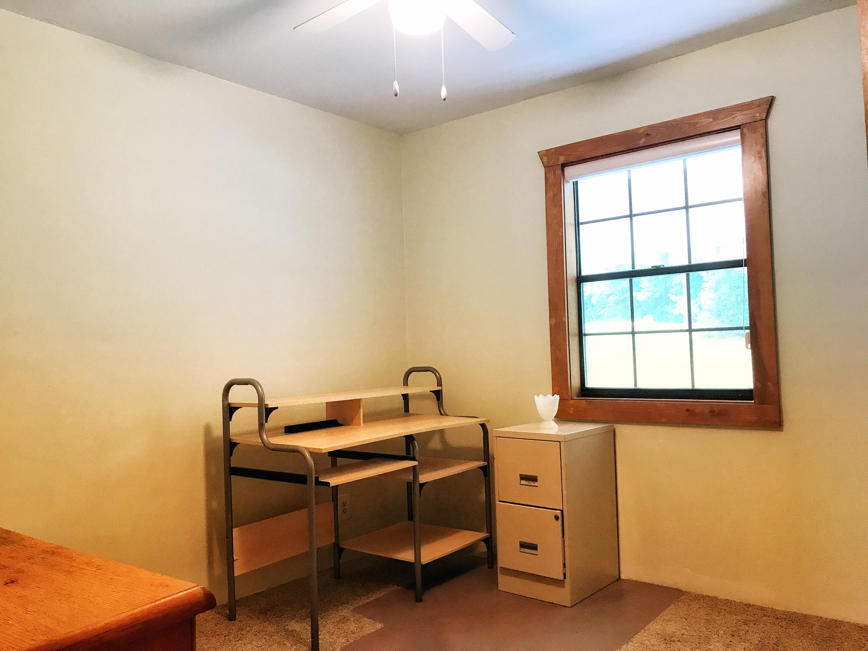 1326 Spring Lake Road DeFuniak Springs, FL 32433 - Photo 6 of 25 a room with a chair and a window