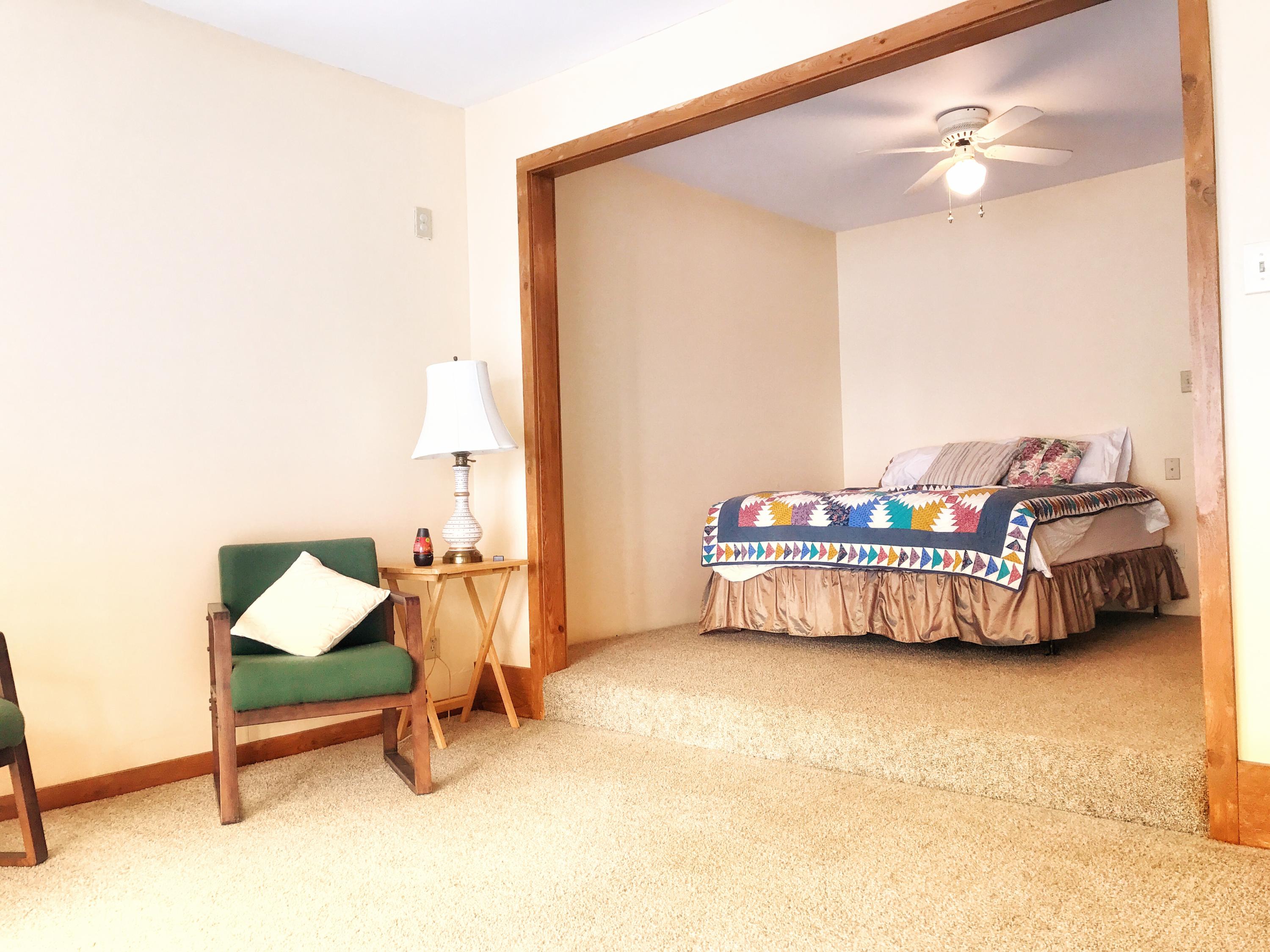 1326 Spring Lake Road DeFuniak Springs, FL 32433 - Photo 8 of 25 a bedroom with a bed and a chandelier