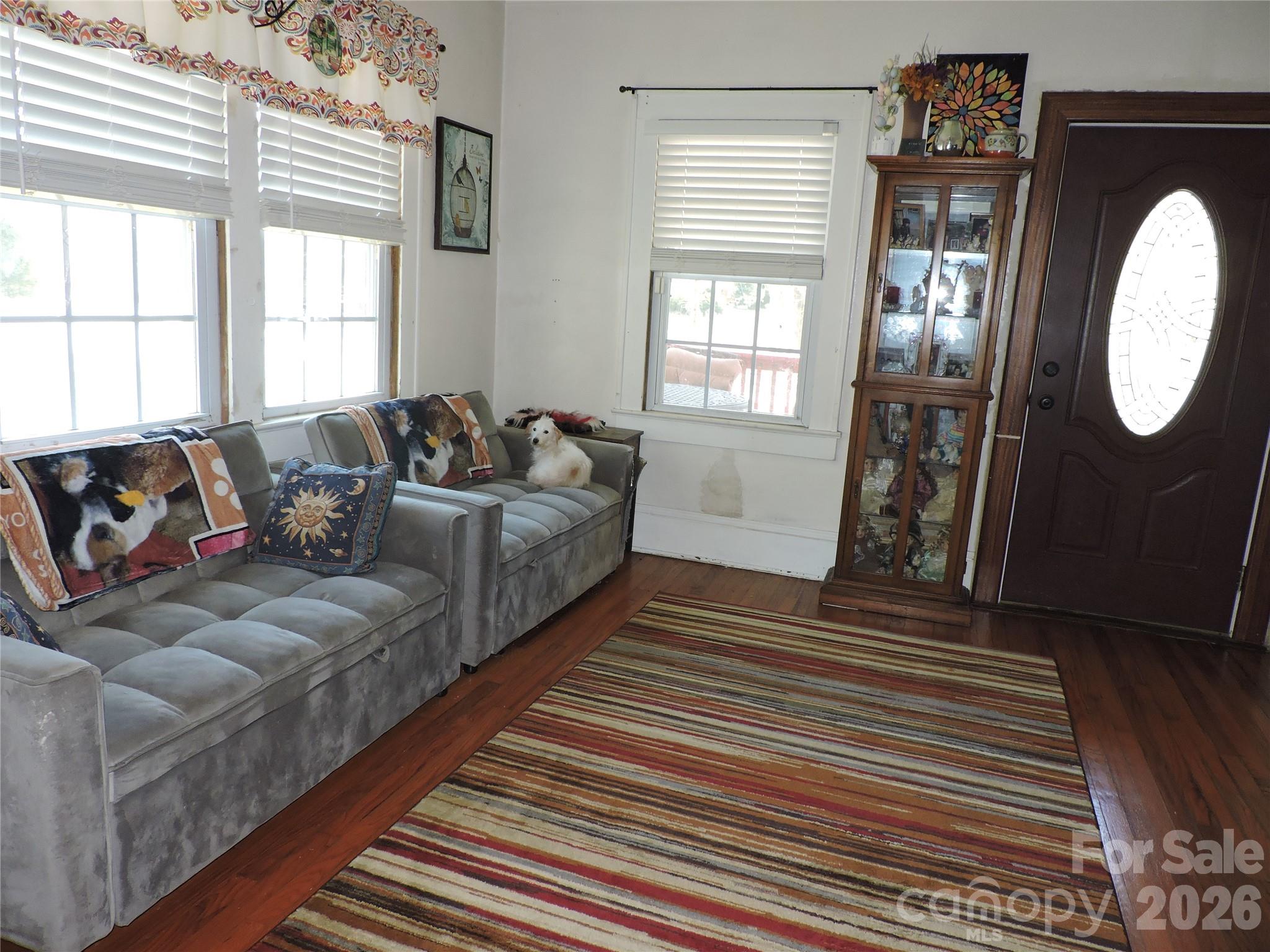 4 Carter Road Weaverville, NC 28787 - Photo 12 of 44 a living room with couches a large mirror with wooden floor