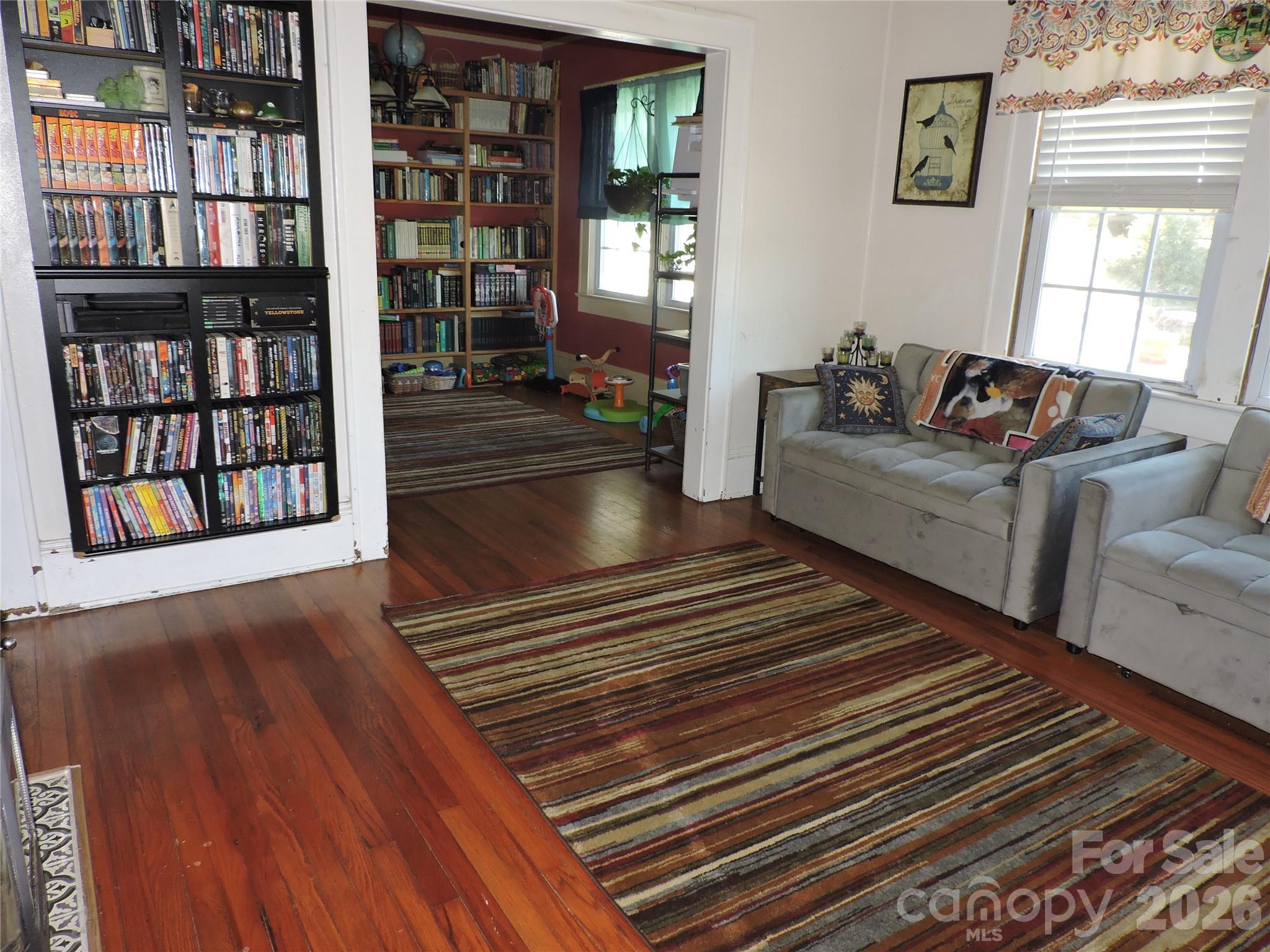 4 Carter Road Weaverville, NC 28787 - Photo 16 of 44 a living room with furniture and a book shelf