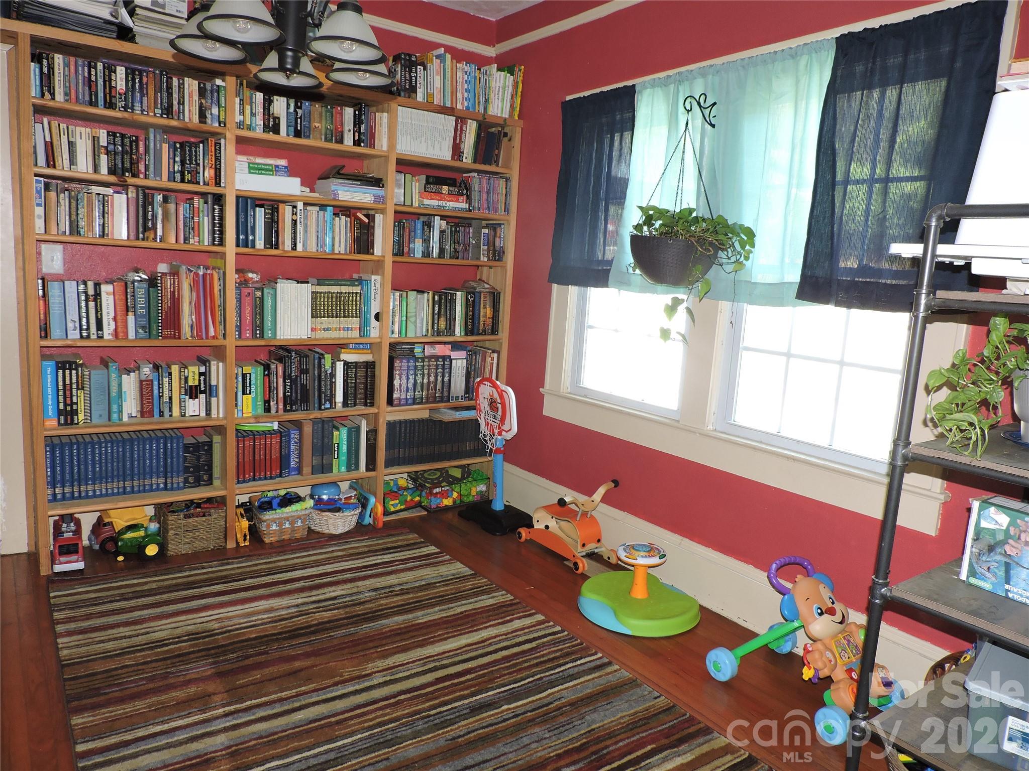 4 Carter Road Weaverville, NC 28787 - Photo 19 of 44 a living room filled with furniture and a book shelf
