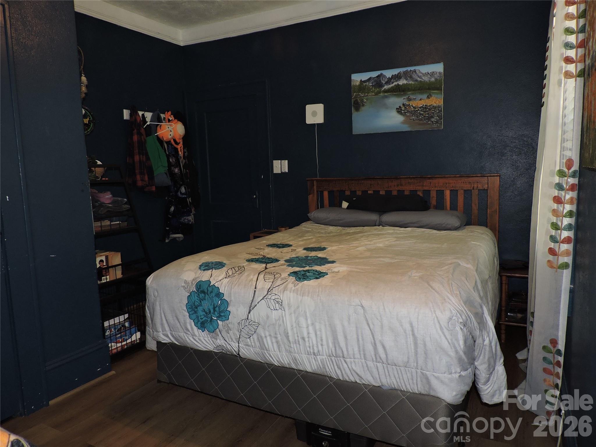 4 Carter Road Weaverville, NC 28787 - Photo 27 of 44 a bed sitting in a bedroom next to a window with lamp
