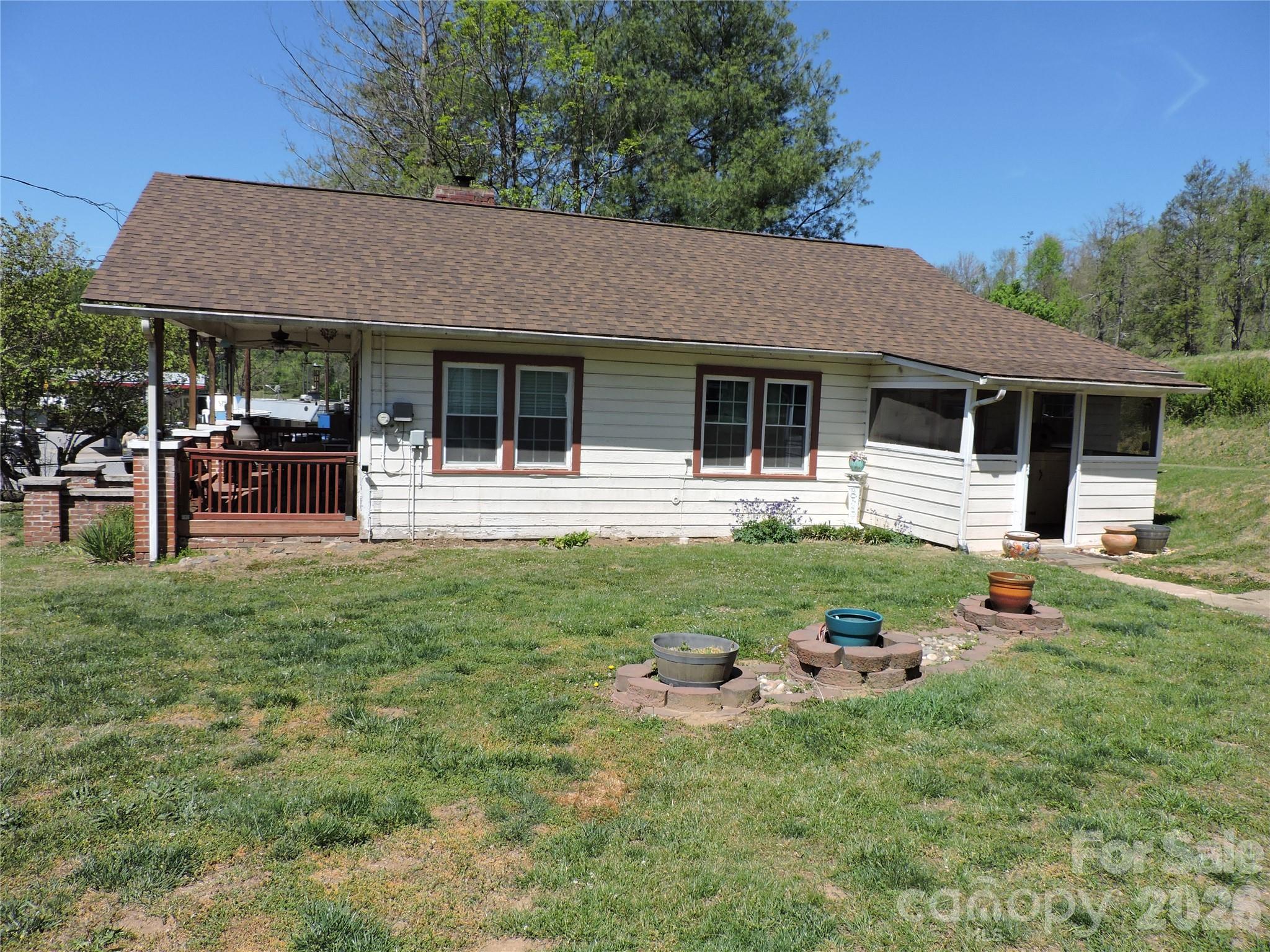 4 Carter Road Weaverville, NC 28787 - Photo 3 of 44 a front view of a house with a yard and green space