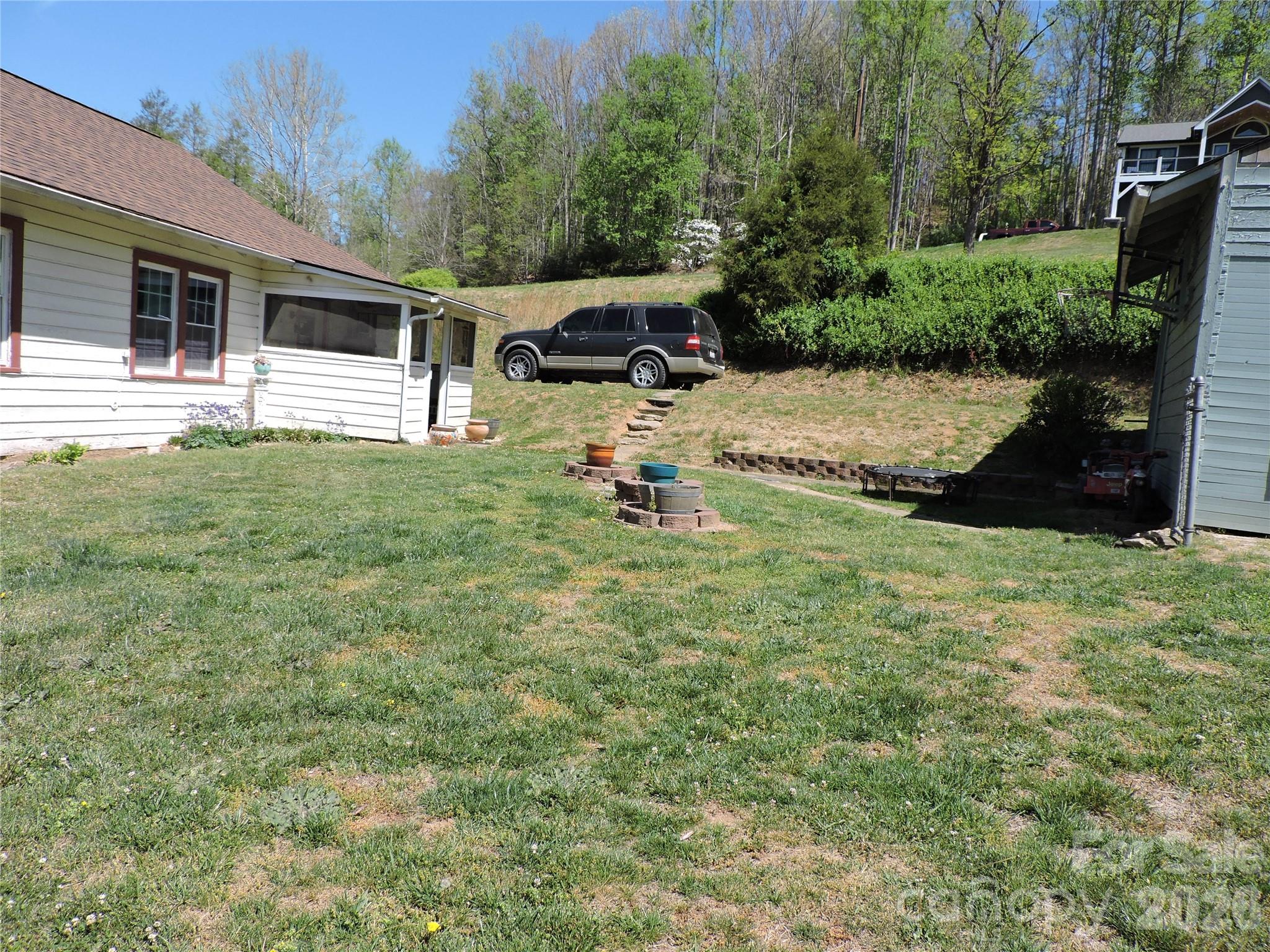 4 Carter Road Weaverville, NC 28787 - Photo 4 of 44 a backyard of a house with seating space