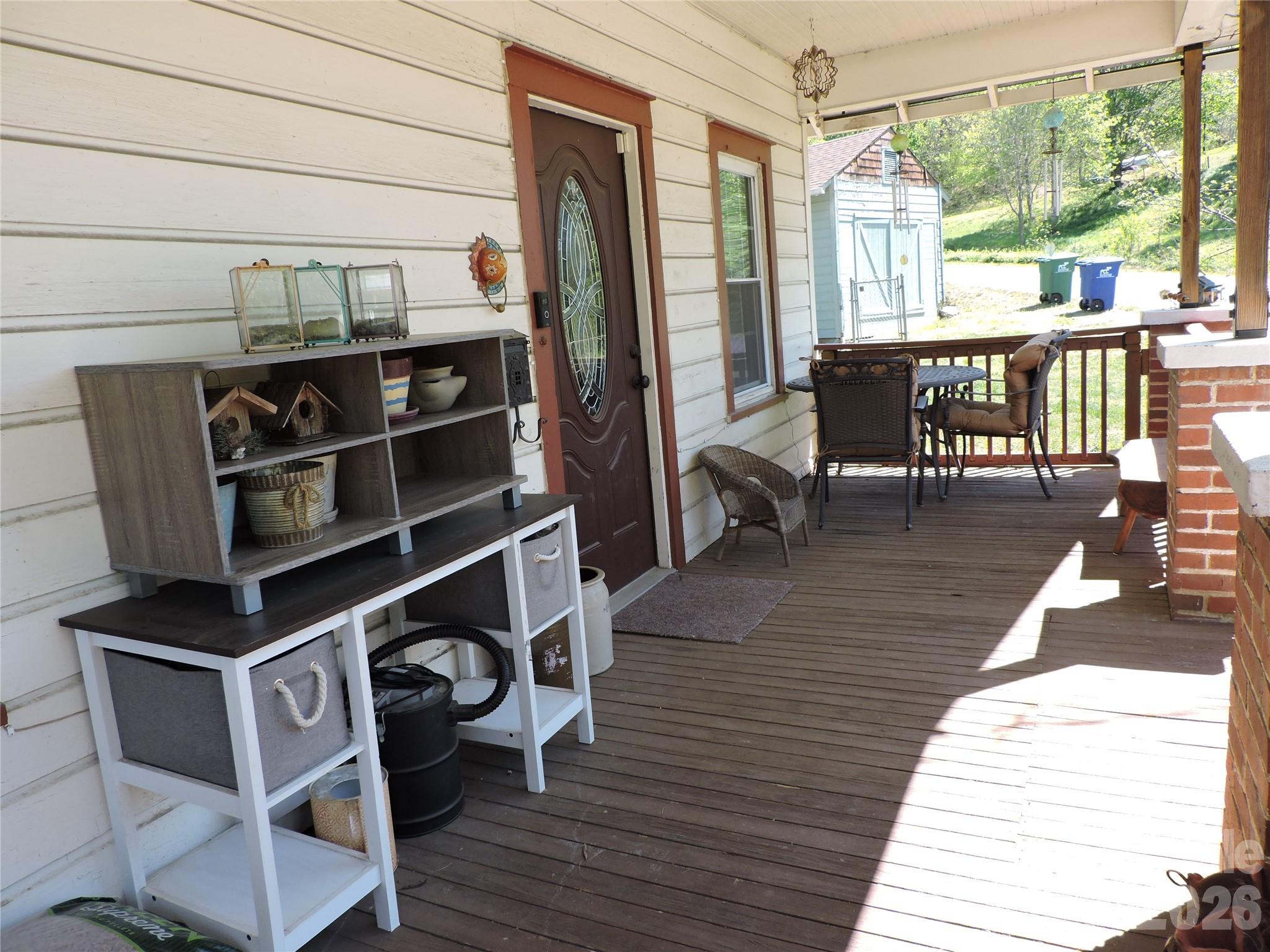 4 Carter Road Weaverville, NC 28787 - Photo 10 of 44 a view of a chairs and table on the wooden deck