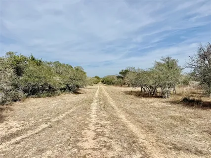 a view of a dry yard with a house
