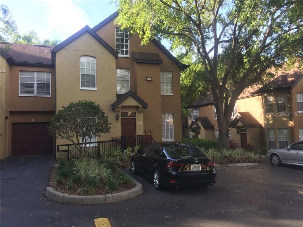 6308 Raleigh Street, Unit 304 Orlando, FL 32835 - Photo 1 of 1 a car parked in front of a house