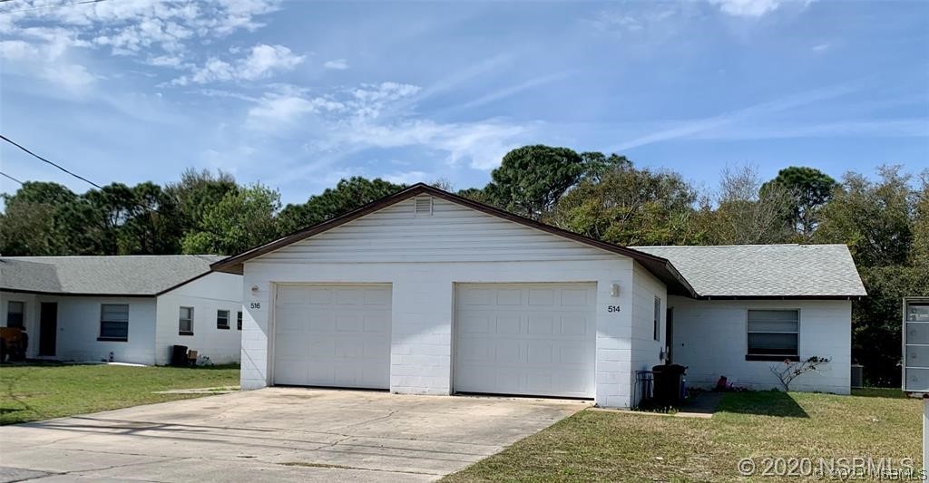 610 South Old County Road Edgewater, FL 32132 - Photo 1 of 10 a front view of a house with a yard and garage