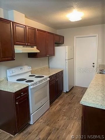 610 South Old County Road Edgewater, FL 32132 - Photo 3 of 10 a kitchen with stainless steel appliances granite countertop a stove a refrigerator and a sink