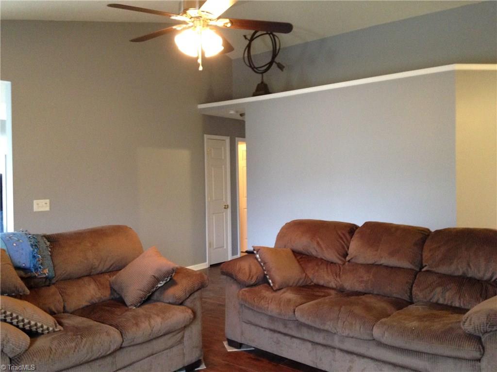 5504 Jason Road Greensboro, NC 27405 - Photo 5 of 10 Vaulted great room, new ceiling fan, new flooring, new paint