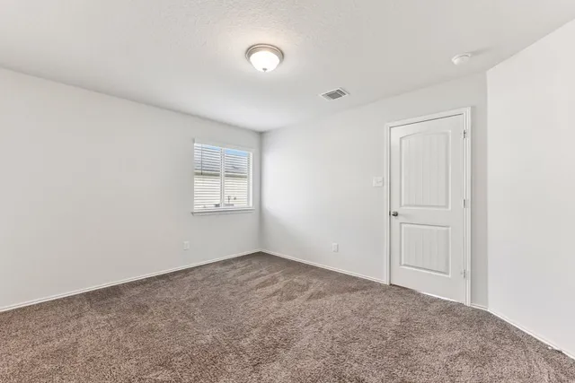 a view of an empty room and a window