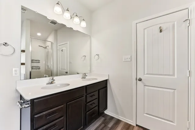 a bathroom with a sink double vanity and a mirror