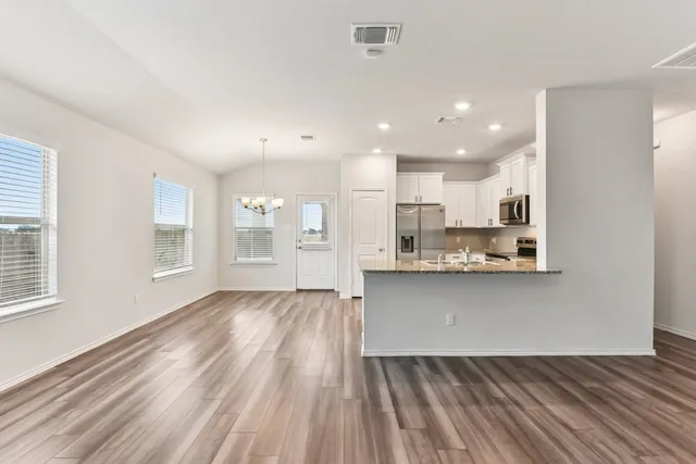 a view of kitchen with wooden floor and window