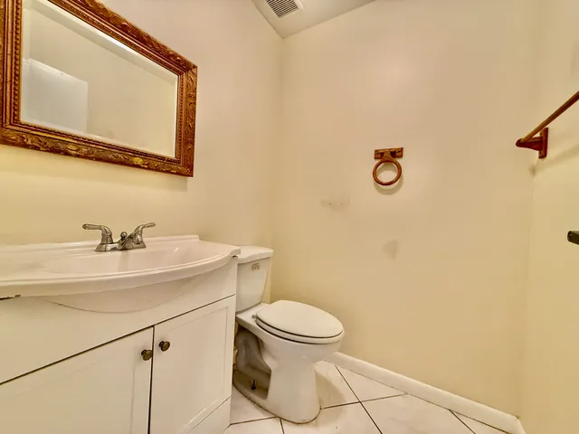 a bathroom with a sink a toilet and mirror