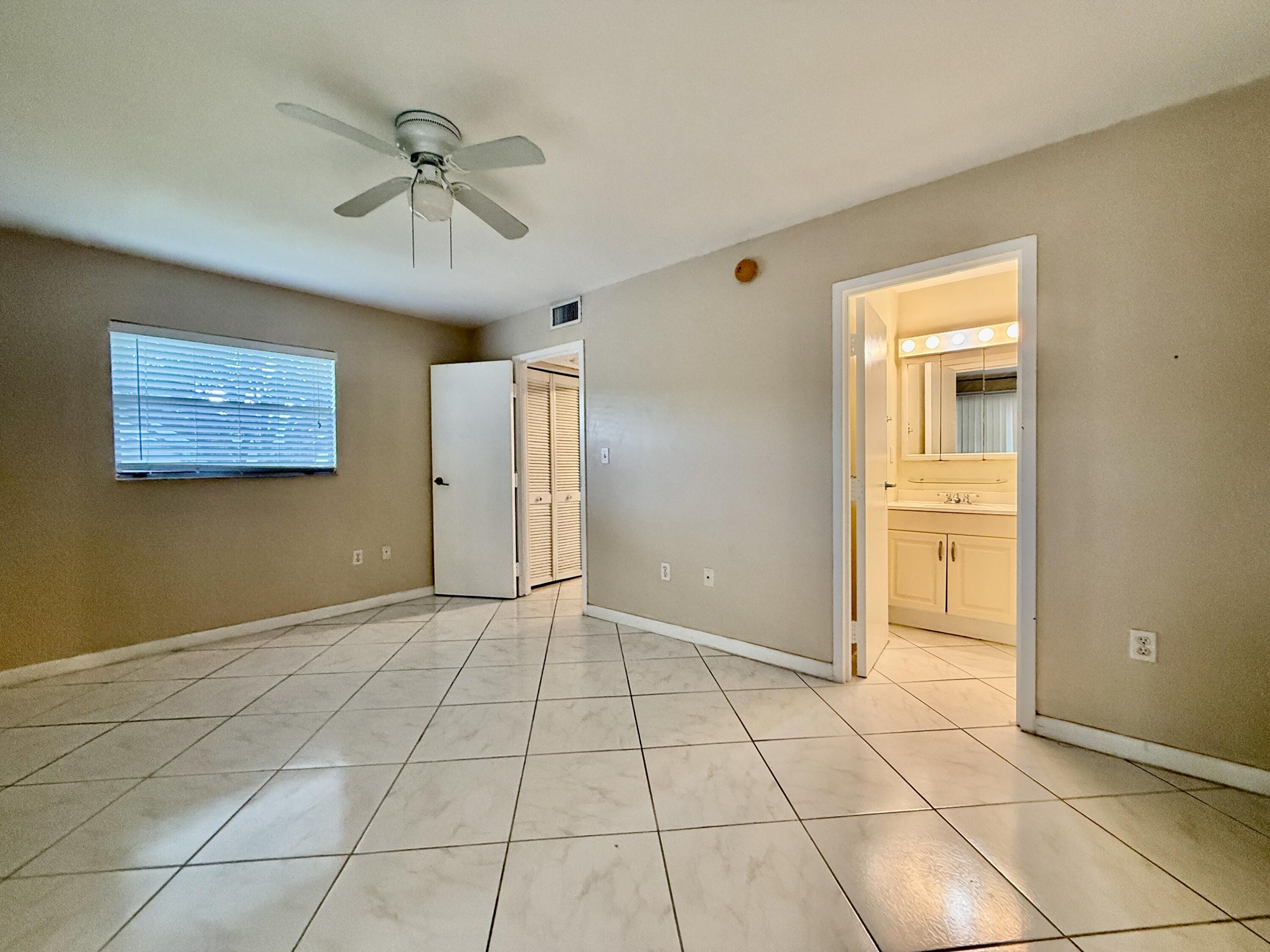 139 Tuscany Lane, Unit 139 Delray Beach, FL 33446 - Photo 8 of 21 a view of an empty room with a window