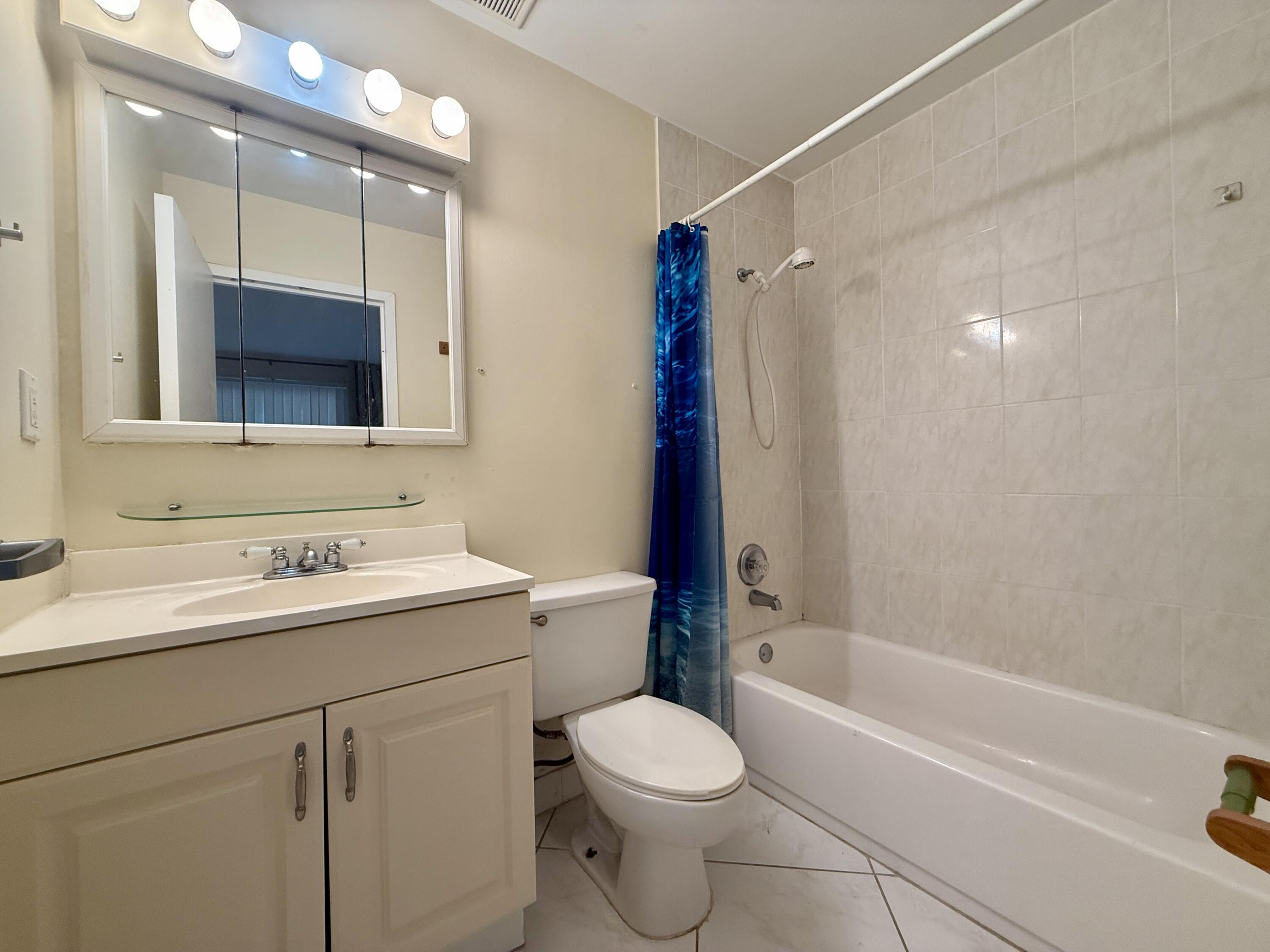 139 Tuscany Lane, Unit 139 Delray Beach, FL 33446 - Photo 9 of 21 a bathroom with a sink a toilet and shower
