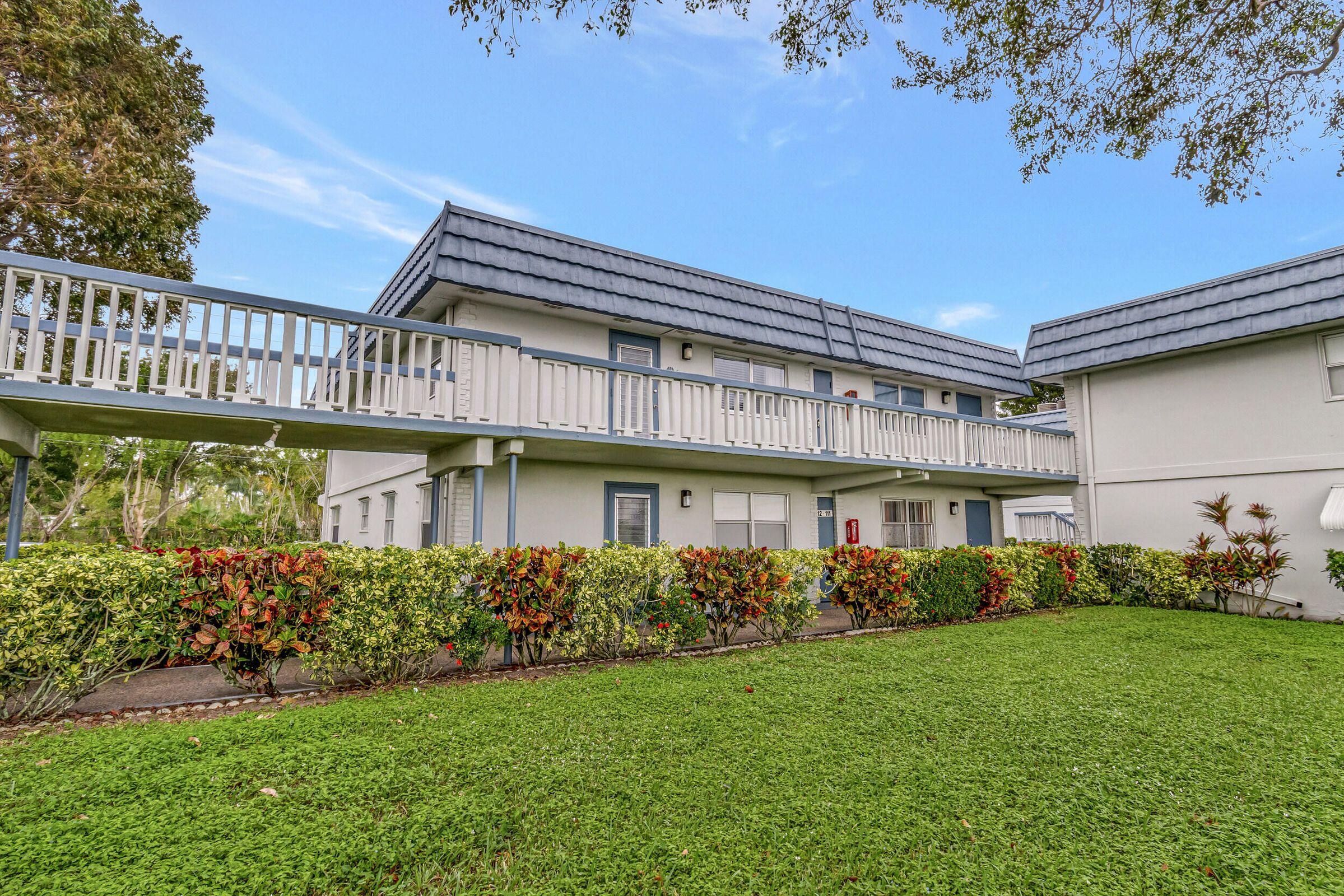 139 Tuscany Lane, Unit 139 Delray Beach, FL 33446 - Photo 10 of 21 a front view of a house with garden